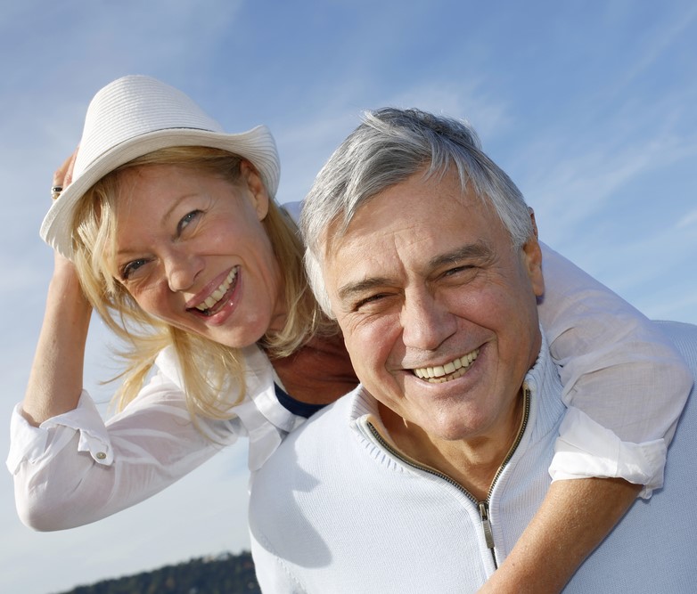 Portrait of cheerful senior couple having fun at the beach-1-1